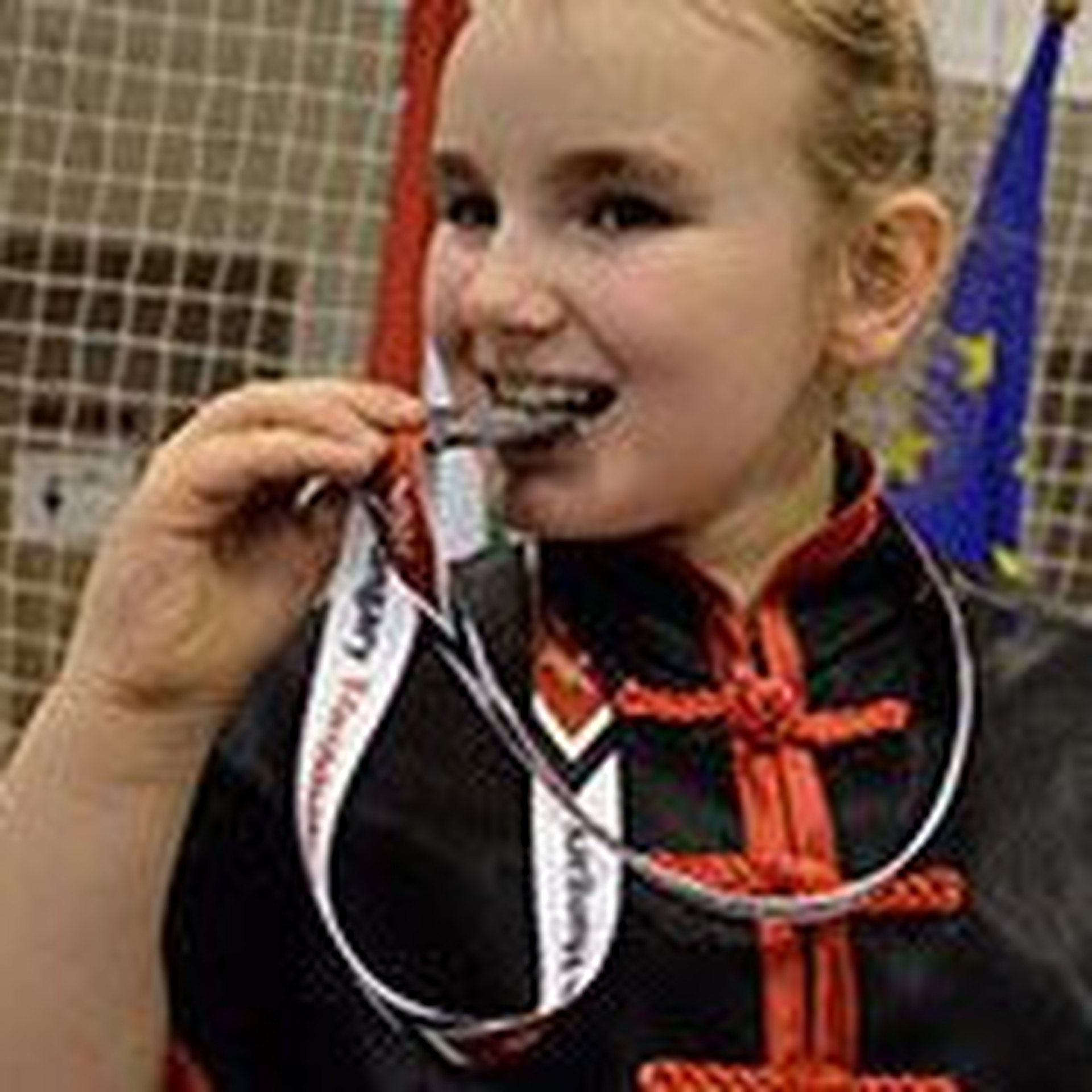 Zdjęcie przedstawiające Zuzannę gryzącą medal